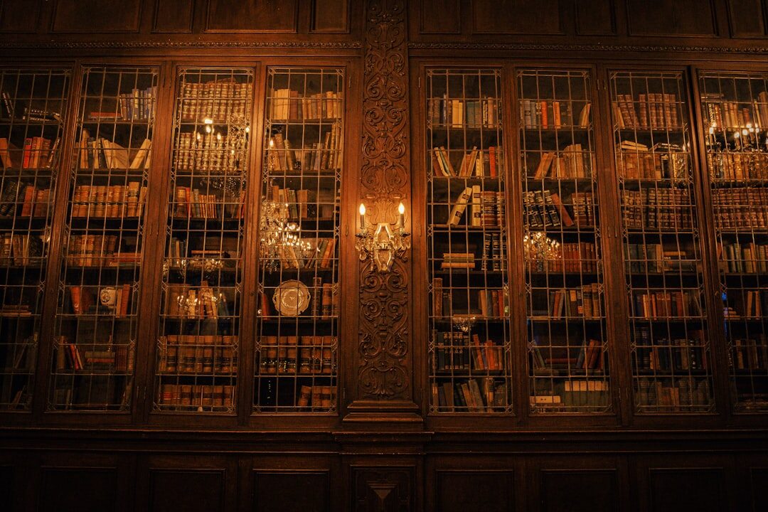 Old library with tall wooden bookshelves and dim lighting