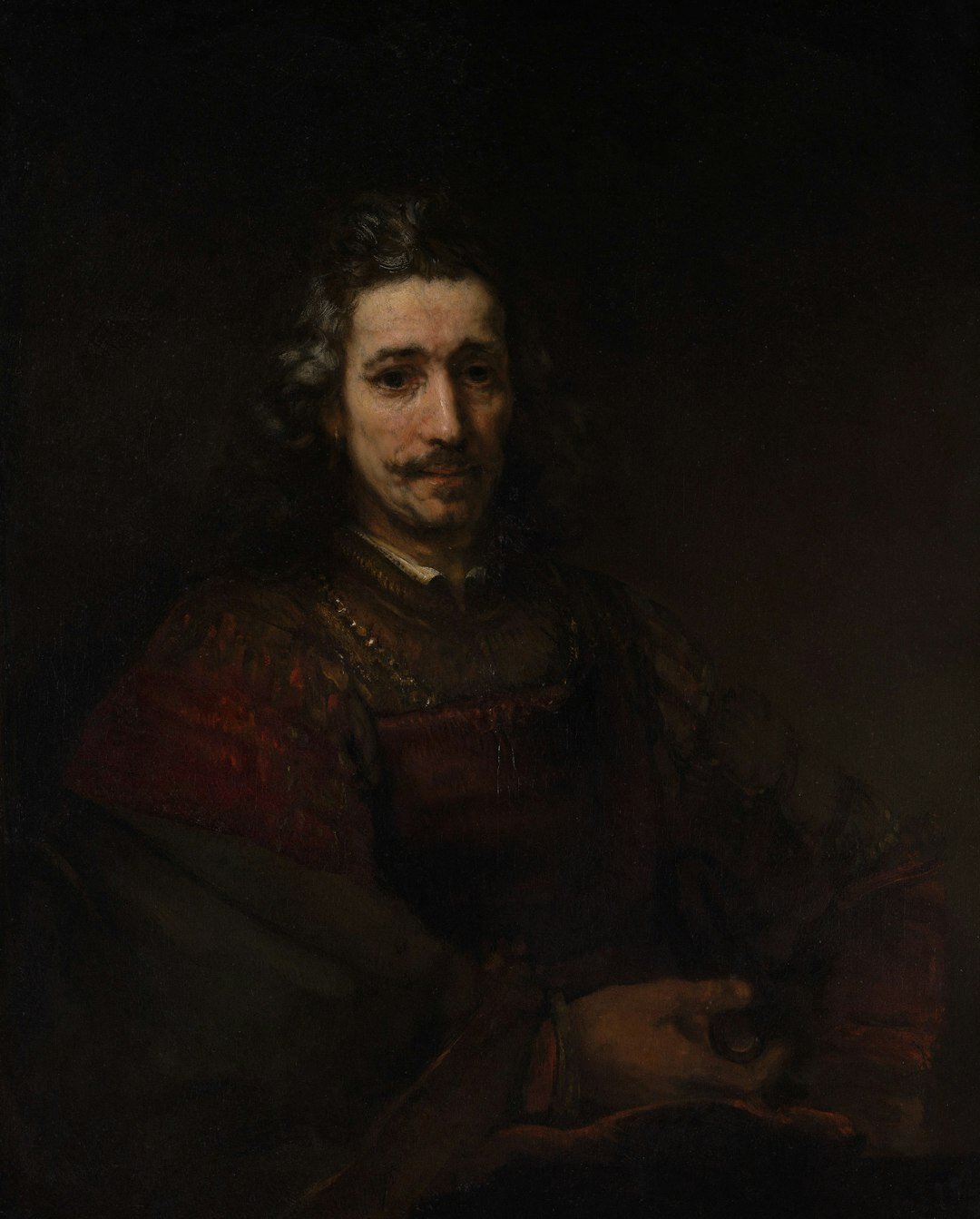 Portrait of a Dutch male author in his sixties with grey hair, seated at a writing desk